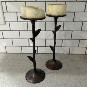 Set of 2.  Holds 3" diameter candles.  10" tall.  Leaf/stick accents.   The TAG